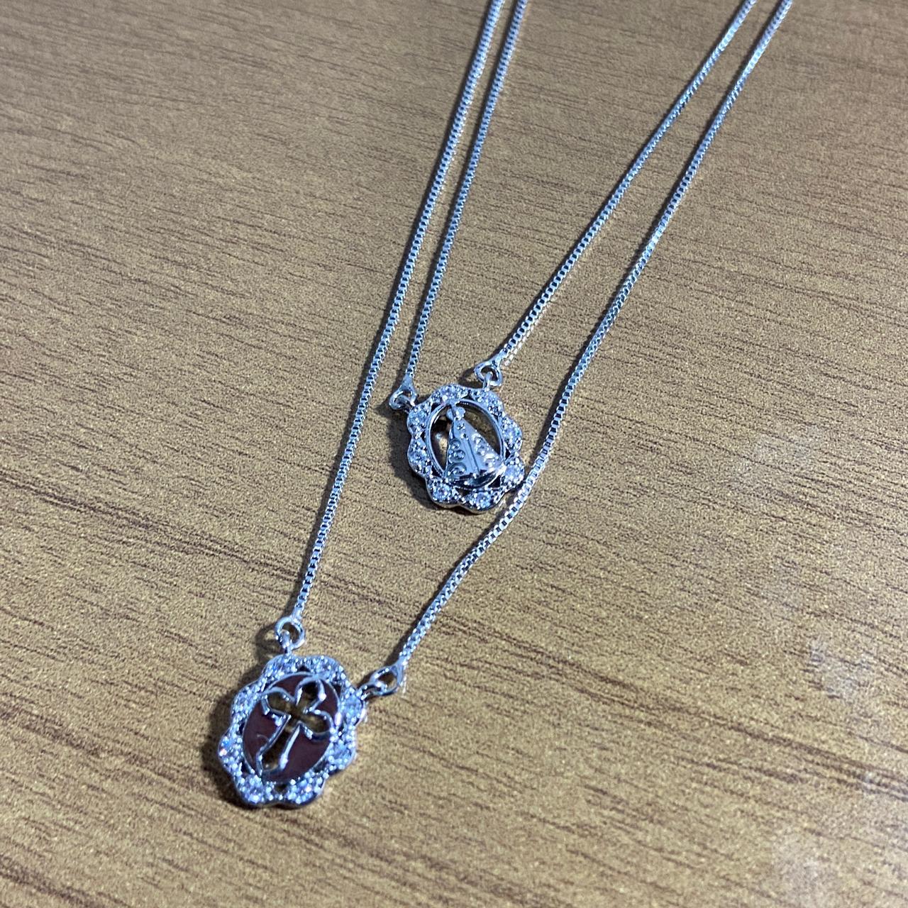 CONJUNTO COLARES PRATEADO NOSSA SENHORA APARECIDA E CRUZ COM STRASS (1 UNIDADE)