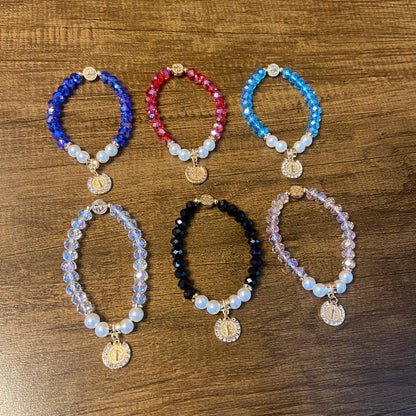 PULSEIRA CRISTAL COM PÉROLA MEDALHA SÃO BENTO CORES SORTIDAS  ( 06 UNIDADES