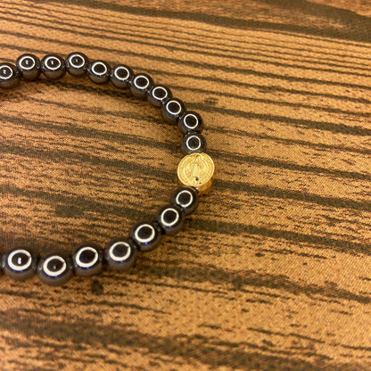 PULSEIRA HEMATITA MEDALHA SÃO BENTO DOURADA (12 UNIDADES)