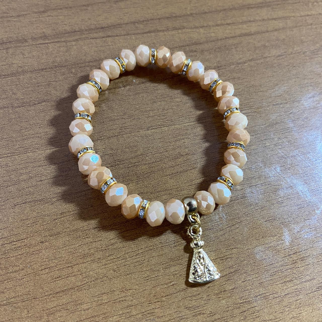 PULSEIRA CRISTAL BEGE NOSSA SENHORA APARECIDA  (06 UNIDADES)