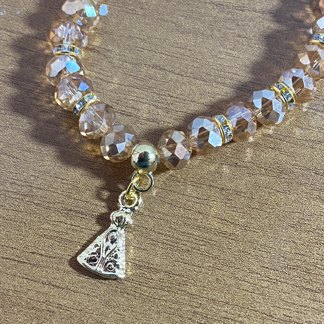 PULSEIRA CRISTAL BEGE TRANSPARENTE NOSSA SENHORA APARECIDA  (06 UNIDADES)