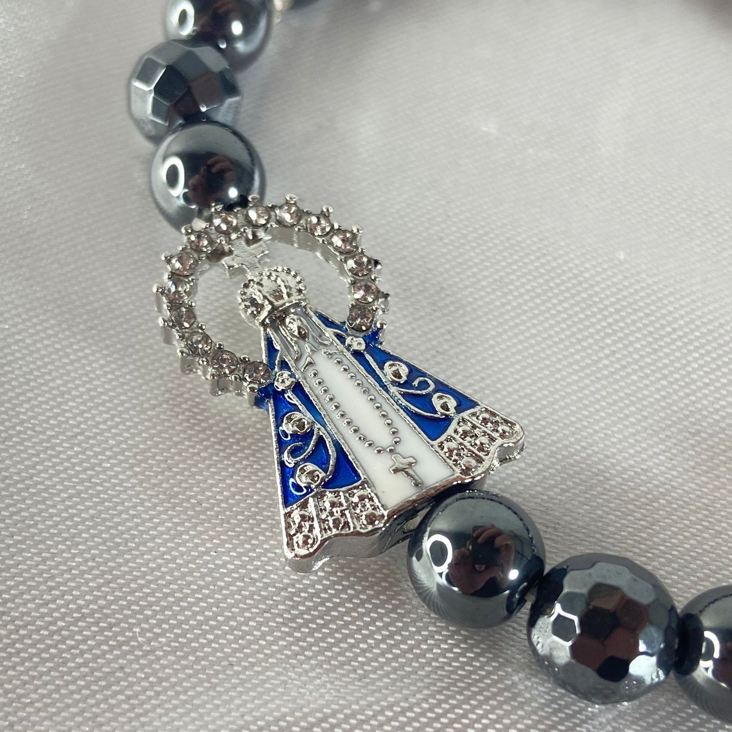 PULSEIRA HEMATITA NOSSA SENHORA APARECIDA COM STRASS (12 UNIDADES)