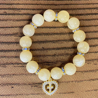 PULSEIRA PÉROLA BEGE COM PINGENTE DE CRUZ COM STRASS 08MM  (03 UNIDADES)