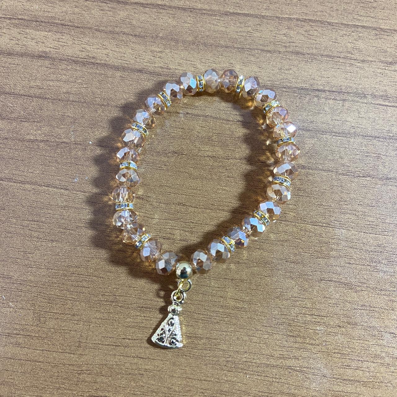 PULSEIRA CRISTAL BEGE TRANSPARENTE NOSSA SENHORA APARECIDA  (06 UNIDADES)