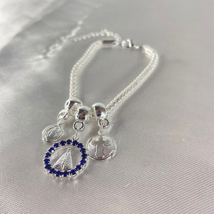 PULSEIRA NÍQUEL REDONDO NOSSA SENHORA APARECIDA COM STRASS AZUL (6 UNIDADES)
