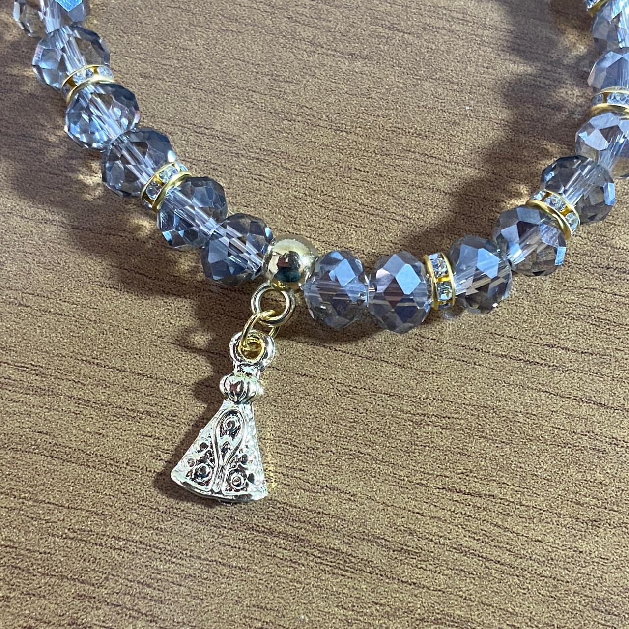 PULSEIRA CRISTAL CINZA TRANSPARENTE NOSSA SENHORA APARECIDA  (06 UNIDADES)
