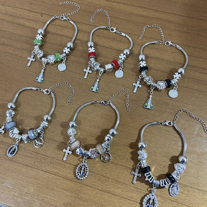 PULSEIRA PRATEADA NOSSA SENHORA APARECIDA MODELOS SORTIDOS COM BERLOQUES  (6 UNIDADES)