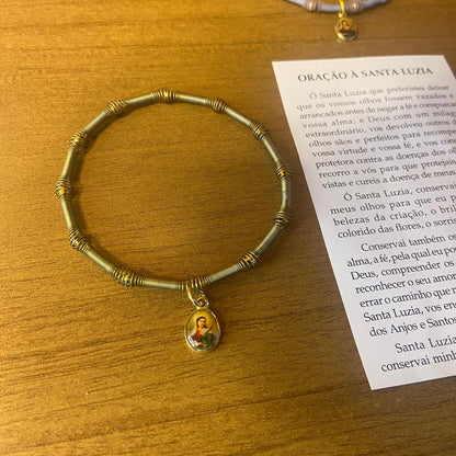 PULSEIRA DE MOLA COM MEDALHA SANTA LUZIA CORES SORTIDAS  (3 UNIDADES)