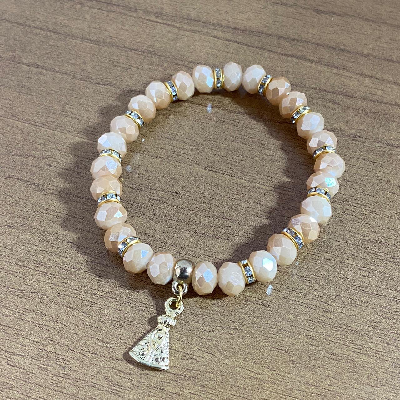 PULSEIRA CRISTAL BEGE NOSSA SENHORA APARECIDA  (06 UNIDADES)