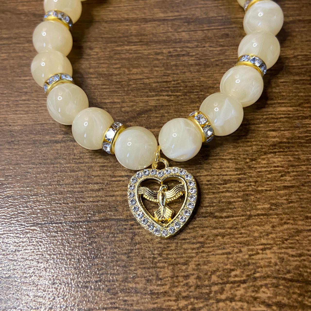 PULSEIRA PÉROLA BEGE COM PINGENTE DIVINO ESPÍRITO SANTO COM STRASS 08MM  (03 UNIDADES)