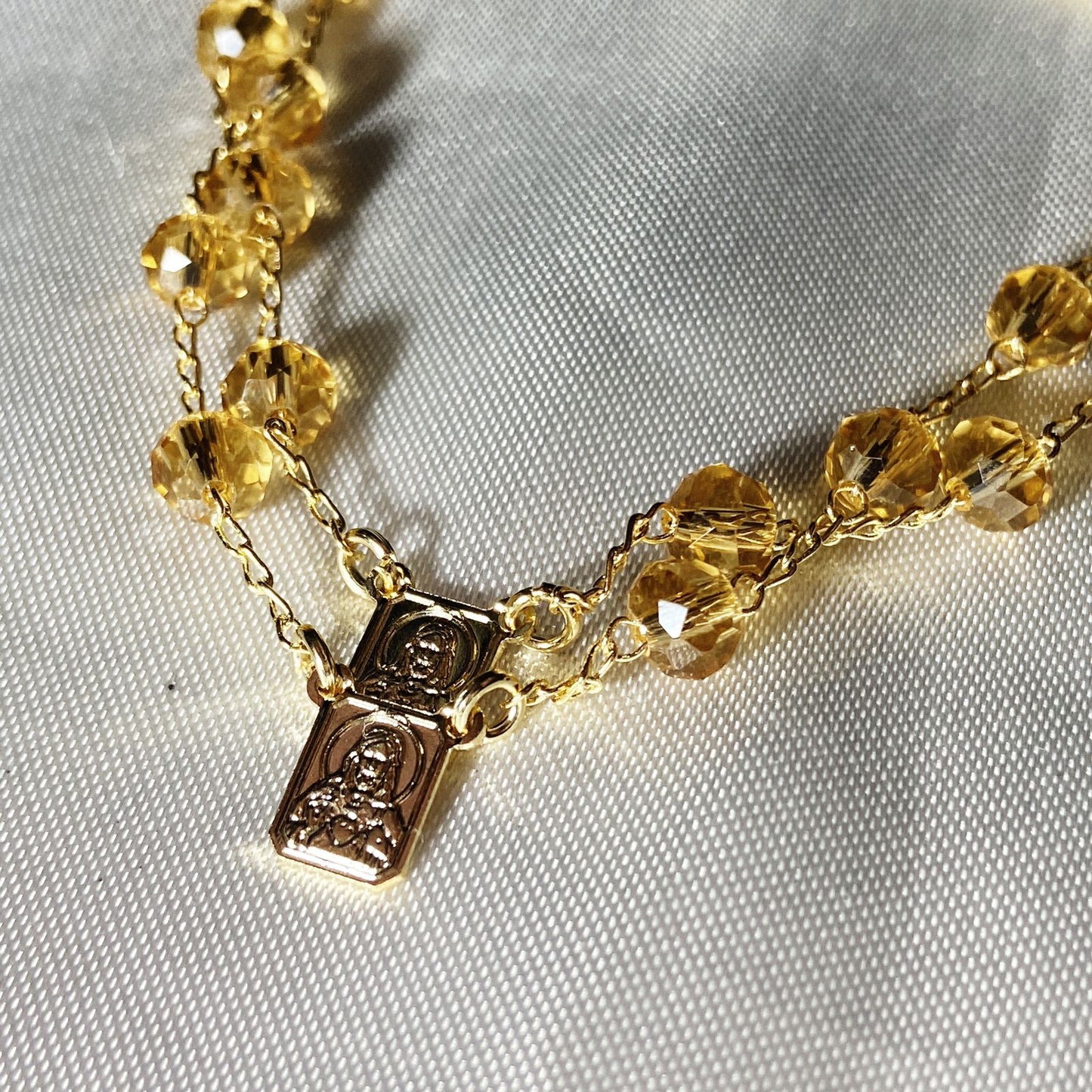 PULSEIRA ESCAPULARIO CRISTAL BEGE TRANSPARENTE (3 UNIDADES)