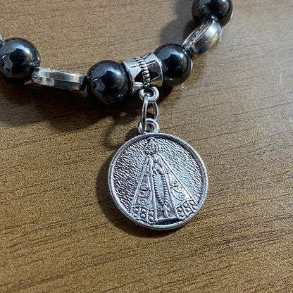 PULSEIRA HEMATITA NOSSA SENHORA APARECIDA MOD3 (12 UNIDADES)