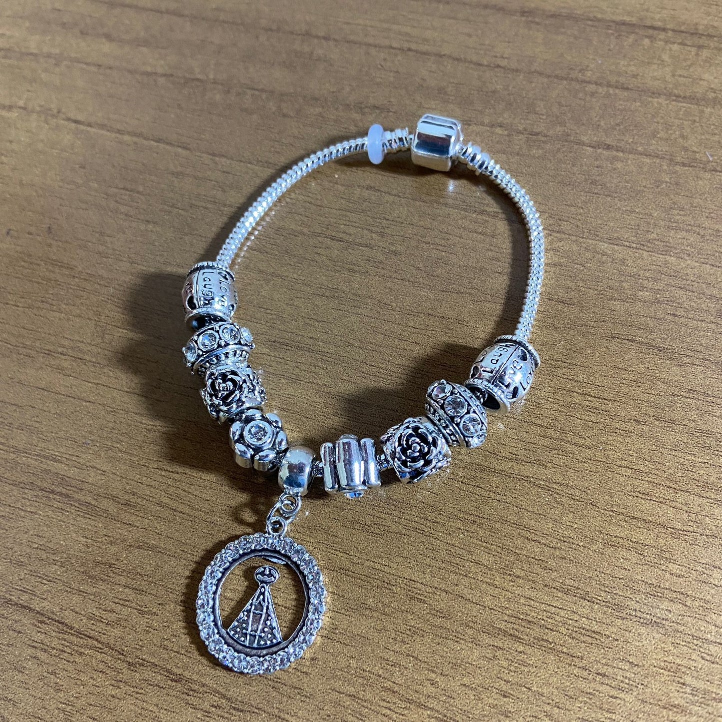 PULSEIRA PRATEADA NOSSA SENHORA APARECIDA COM BERLOQUES MOD2  (1 UNIDADE)