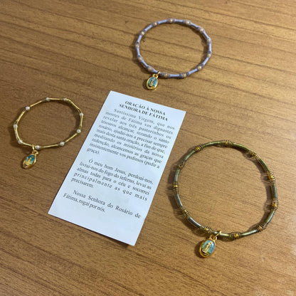 PULSEIRA DE MOLA COM MEDALHA NOSSA SENHORA DE FÁTIMA CORES SORTIDAS  (3 UNIDADES)