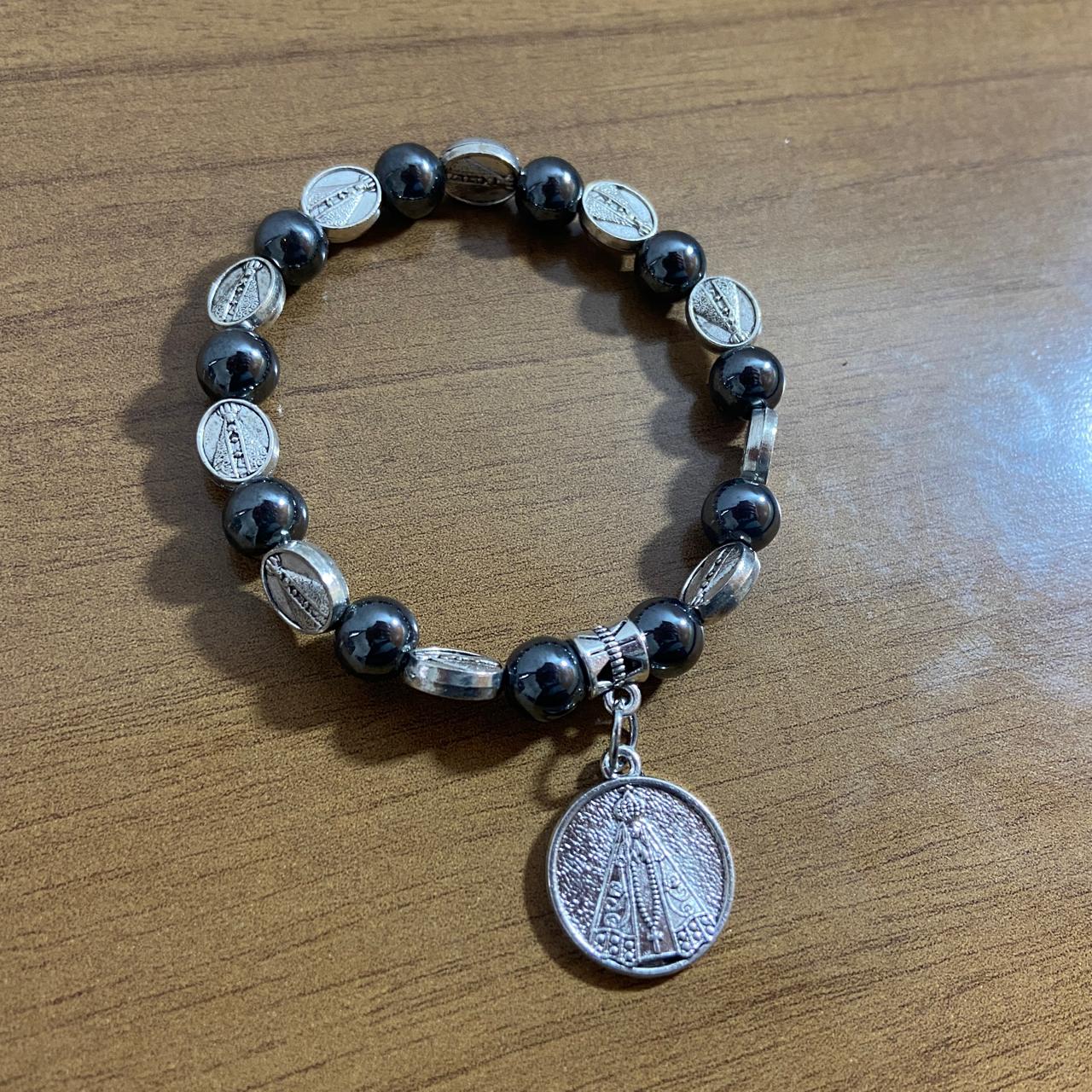 PULSEIRA HEMATITA NOSSA SENHORA APARECIDA MOD3 (12 UNIDADES)