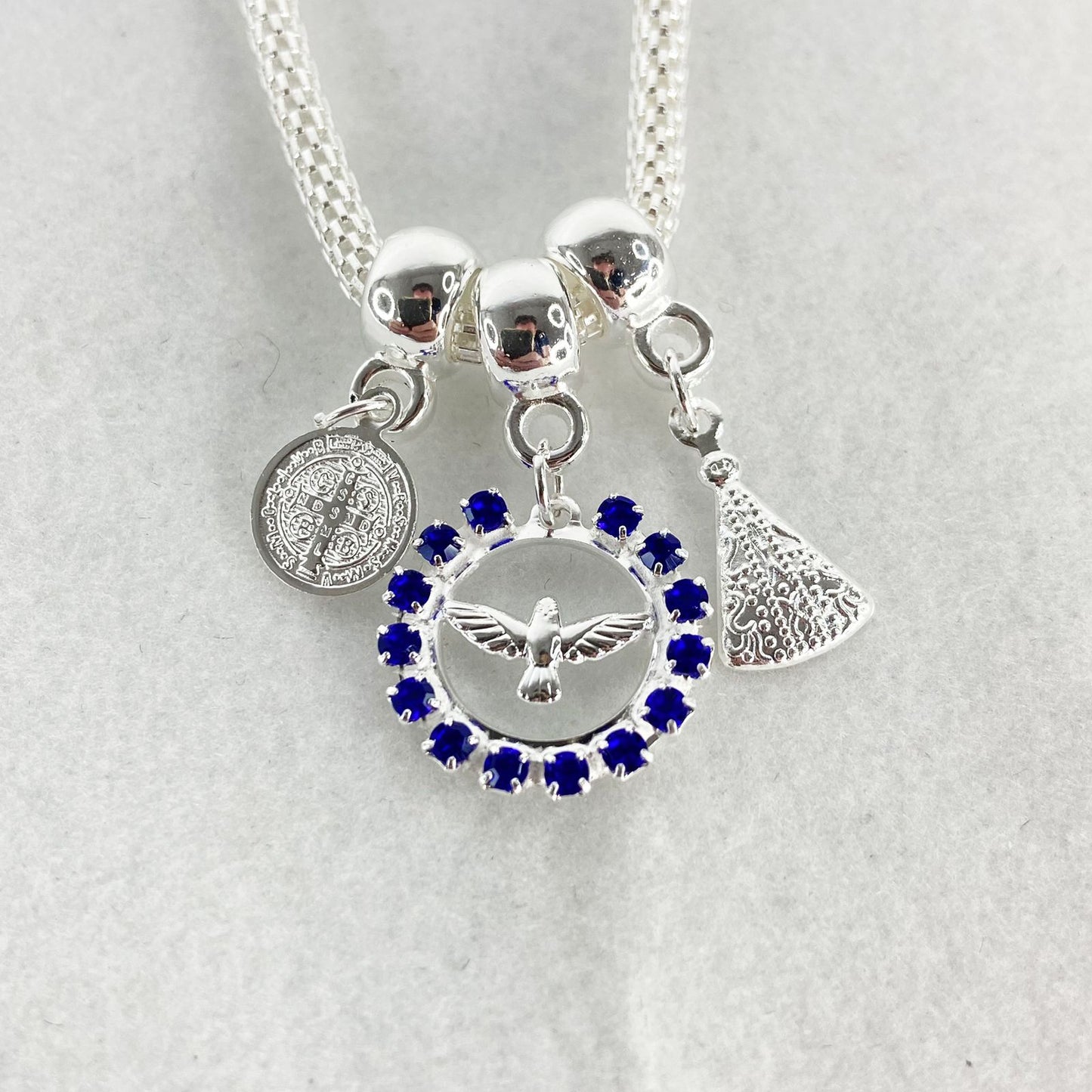 PULSEIRA NÍQUEL DIVINO ESPIRITO SANTO COM STRASS AZUL  (6 UNIDADES)