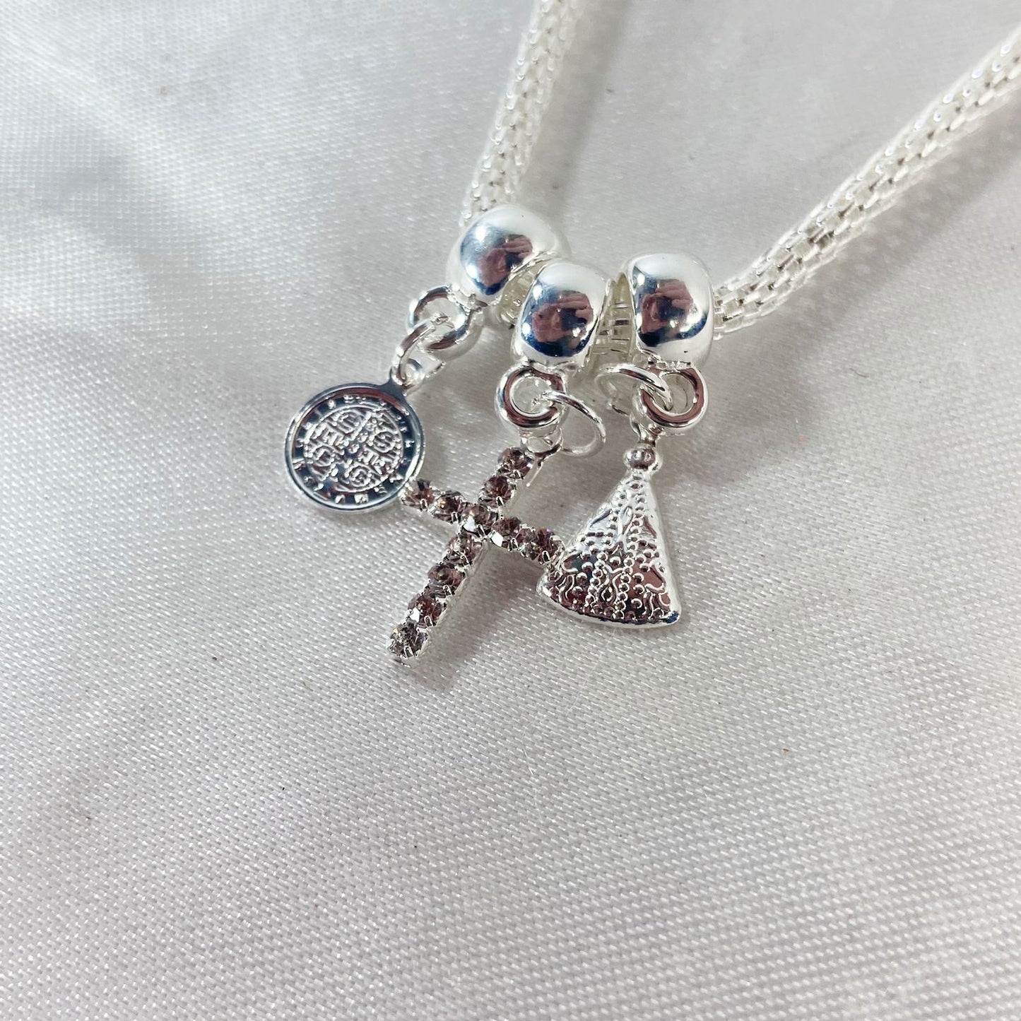 PULSEIRA NÍQUEL CRUZ COM STRASS BRANCO (6 UNIDADES)